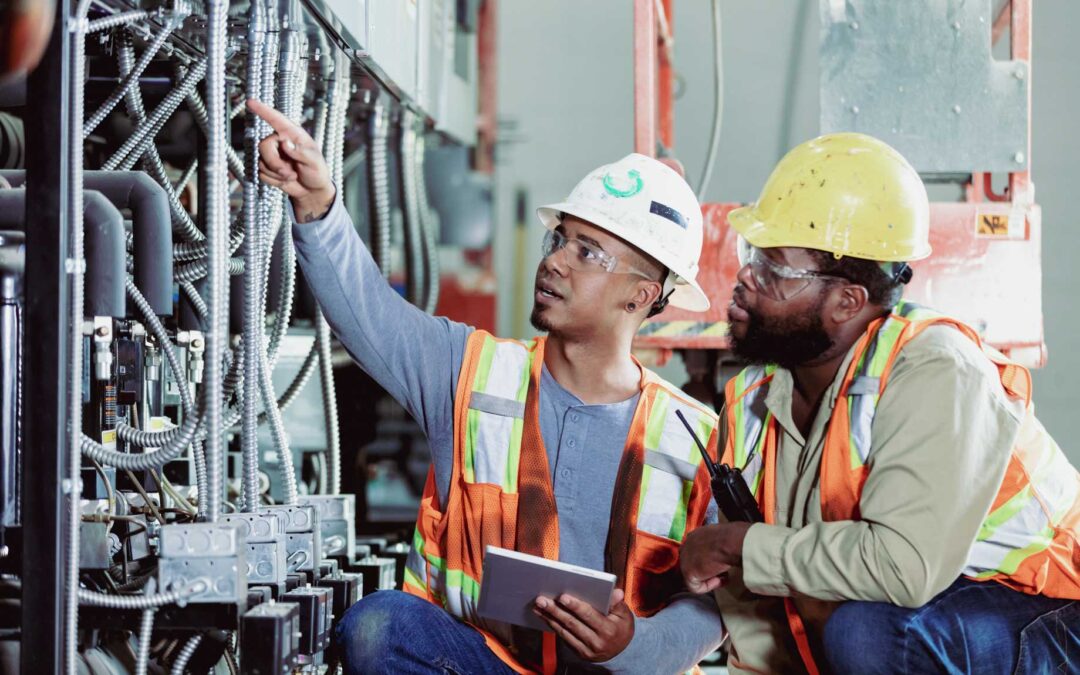Two Workers Inspecting Industrial Refrigeration Equipment